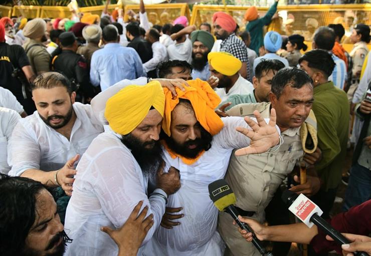 Education and PR minister Harjot Singh Bains in police custody, his turban tossed in air dur to water canon